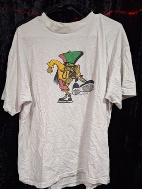 This vintage 90s Kik Wear Inc. street-style T-shirt features a colorful graphic
